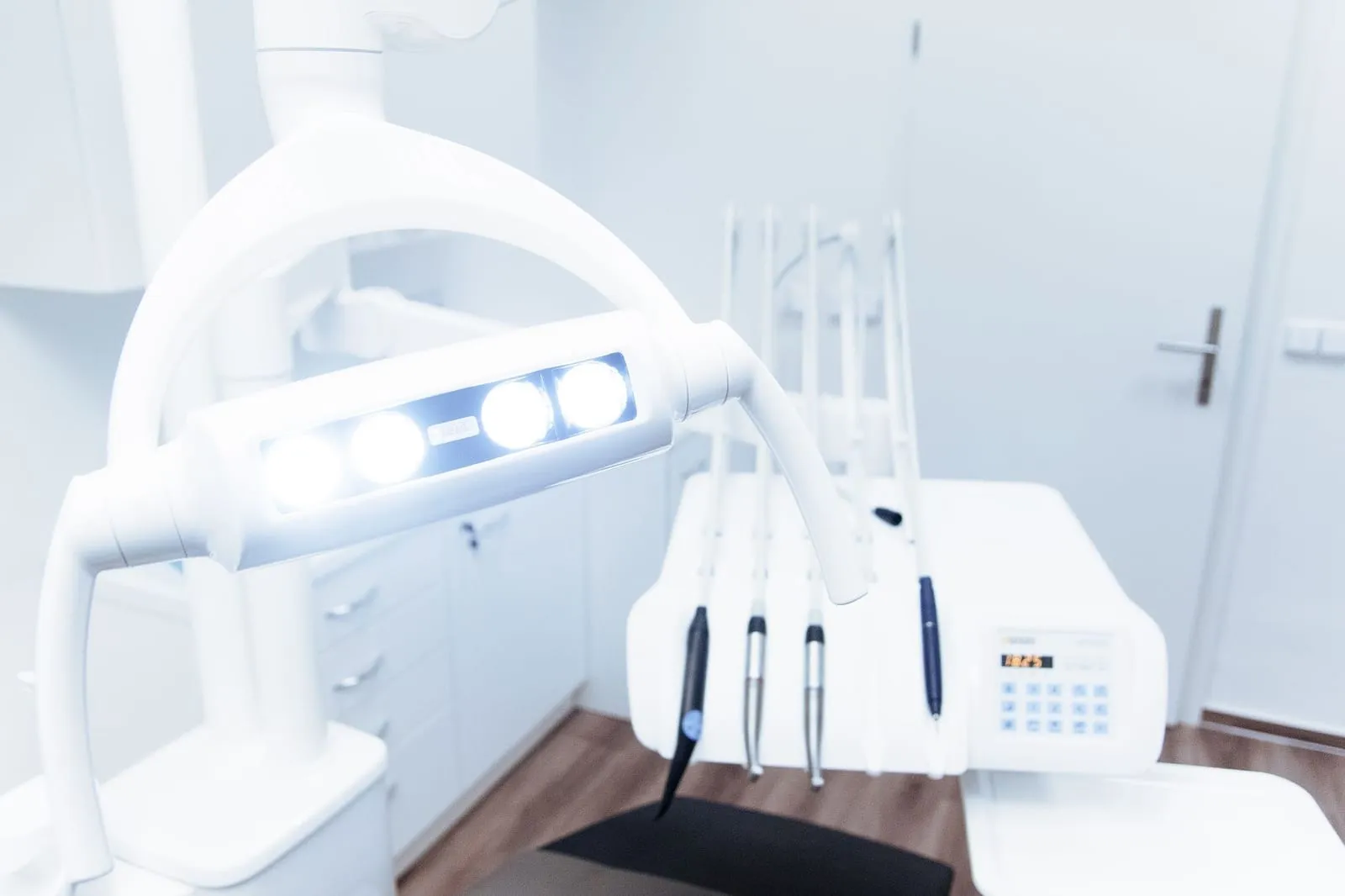 Clean, modern dental equipment beneath a treatment light