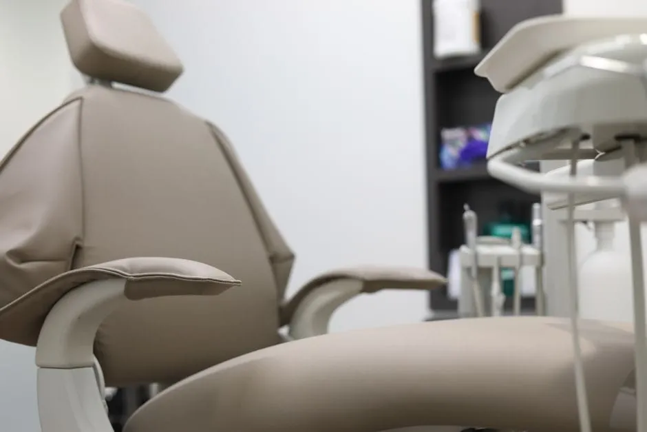 A tidy, calm dental treatment room with a modern chair