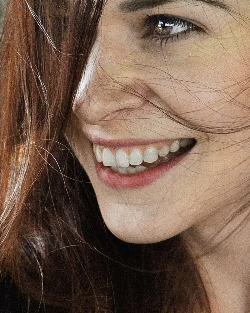 A woman with a bright, natural, healthy smile