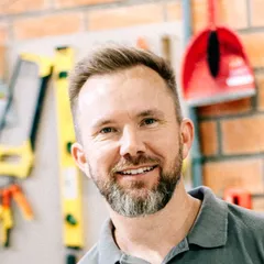 Dan Ellery, smiling, in a grey work polo