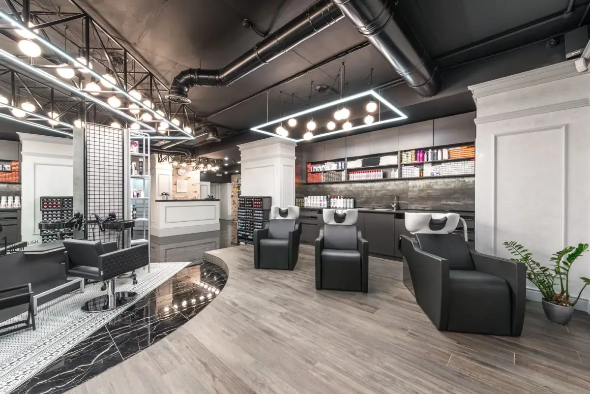Interior of Lumière Hair & Beauty — a calm salon with styling chairs, plaster walls and warm bulb lighting