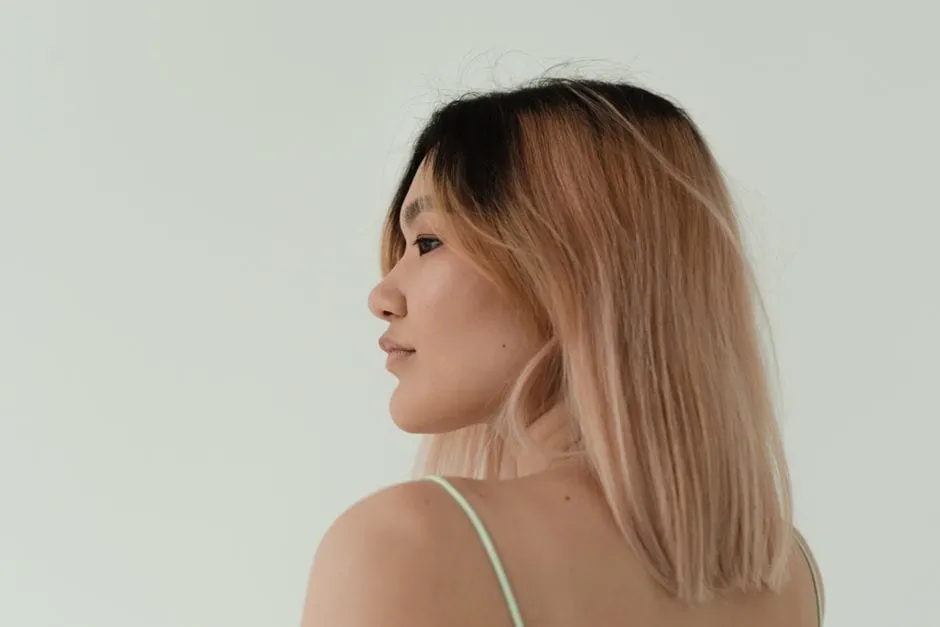 Close-up of a client with sunlit, hand-painted balayage in soft caramel tones